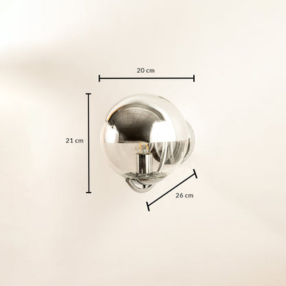 Shiny chrome globe wall lamp with reflective modern design shown with height 20 cm width 20 cm and depth 14 cm suitable for chic contemporary décor.