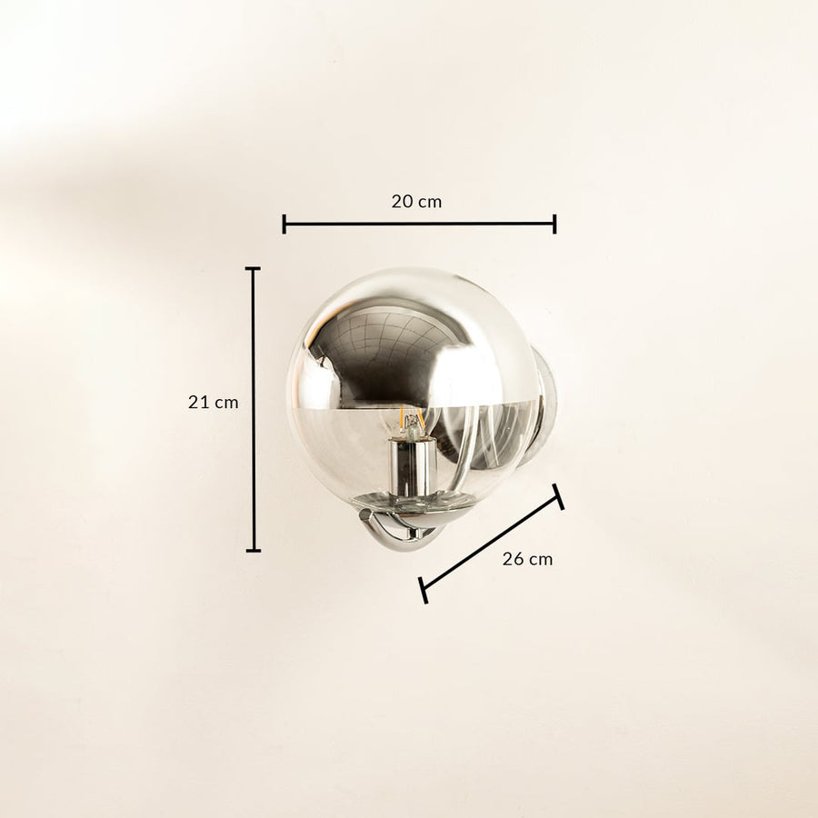 Shiny chrome globe wall lamp with reflective modern design shown with height 20 cm width 20 cm and depth 14 cm suitable for chic contemporary décor.