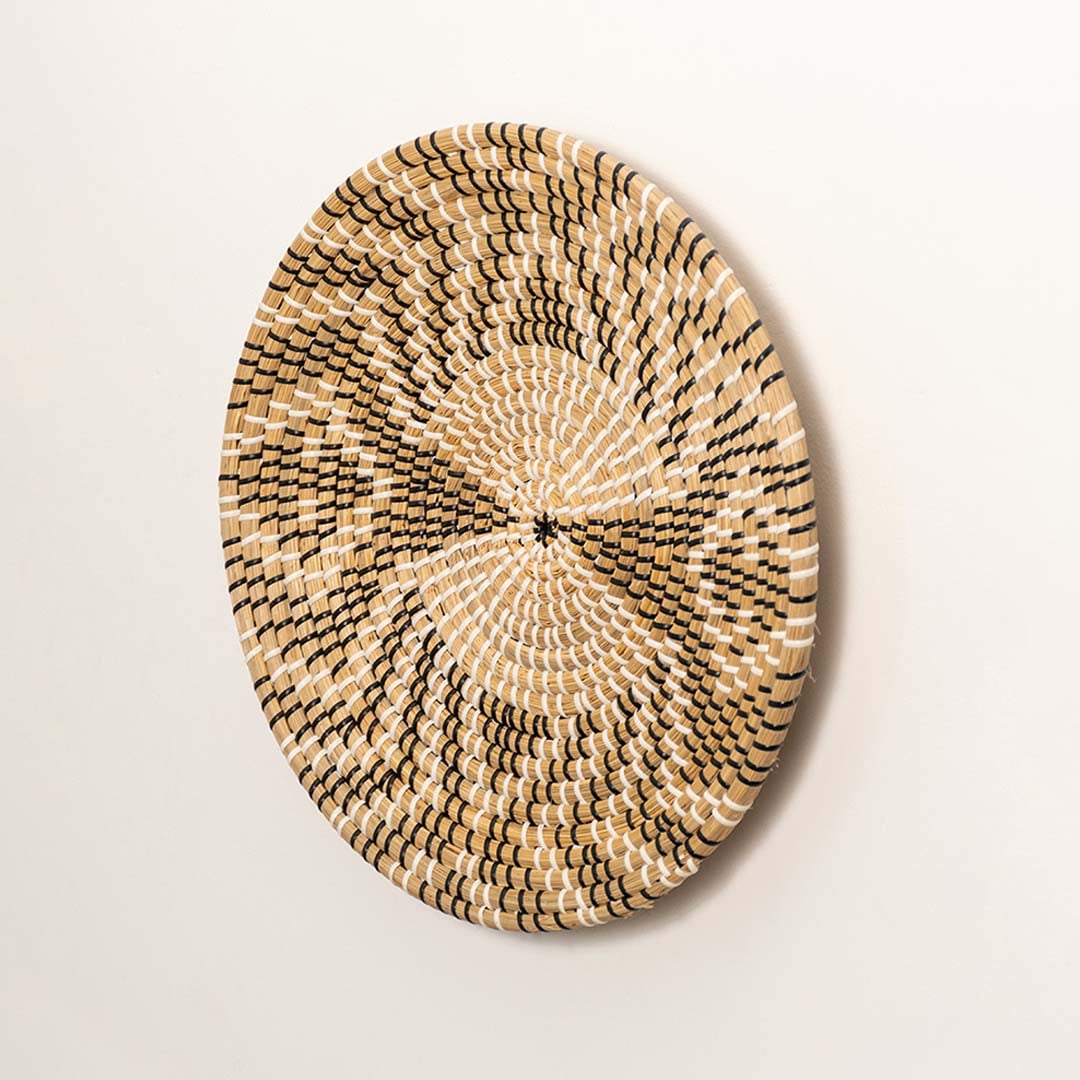 Side profile of round woven seagrass basket showing depth handwoven edges and sturdy natural fiber build.