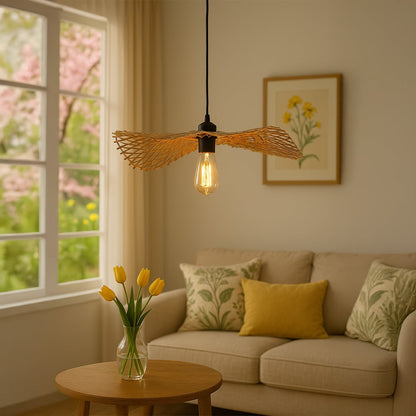 Handwoven rattan pendant light with exposed bulb glowing warmly above coffee table in cozy living room.
