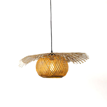 Rattan pendant light with wide handwoven bamboo shade turned on glowing softly against plain white background.