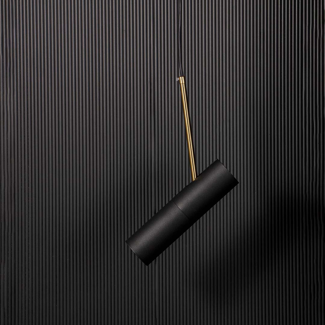 Contemporary black cylindrical pendant lamp with golden detail elegant ceiling light fixture for modern home interior styling.