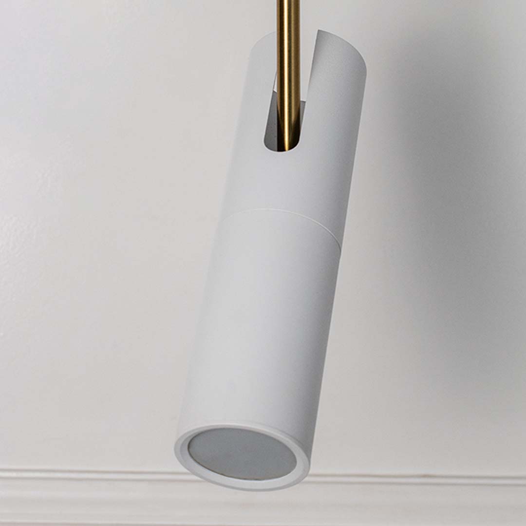 Closeup of elegant white cylindrical pendant light with golden detail modern ceiling lamp for luxury home interior decoration.