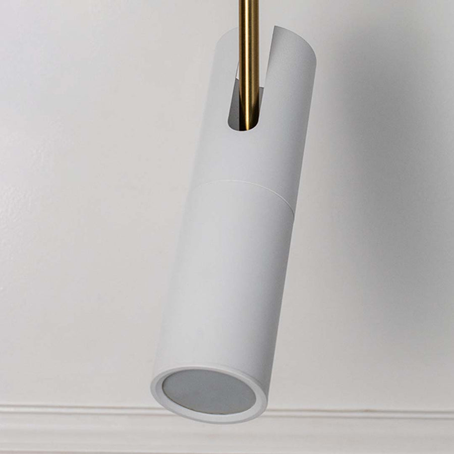 Closeup of elegant white cylindrical pendant light with golden detail modern ceiling lamp for luxury home interior decoration.