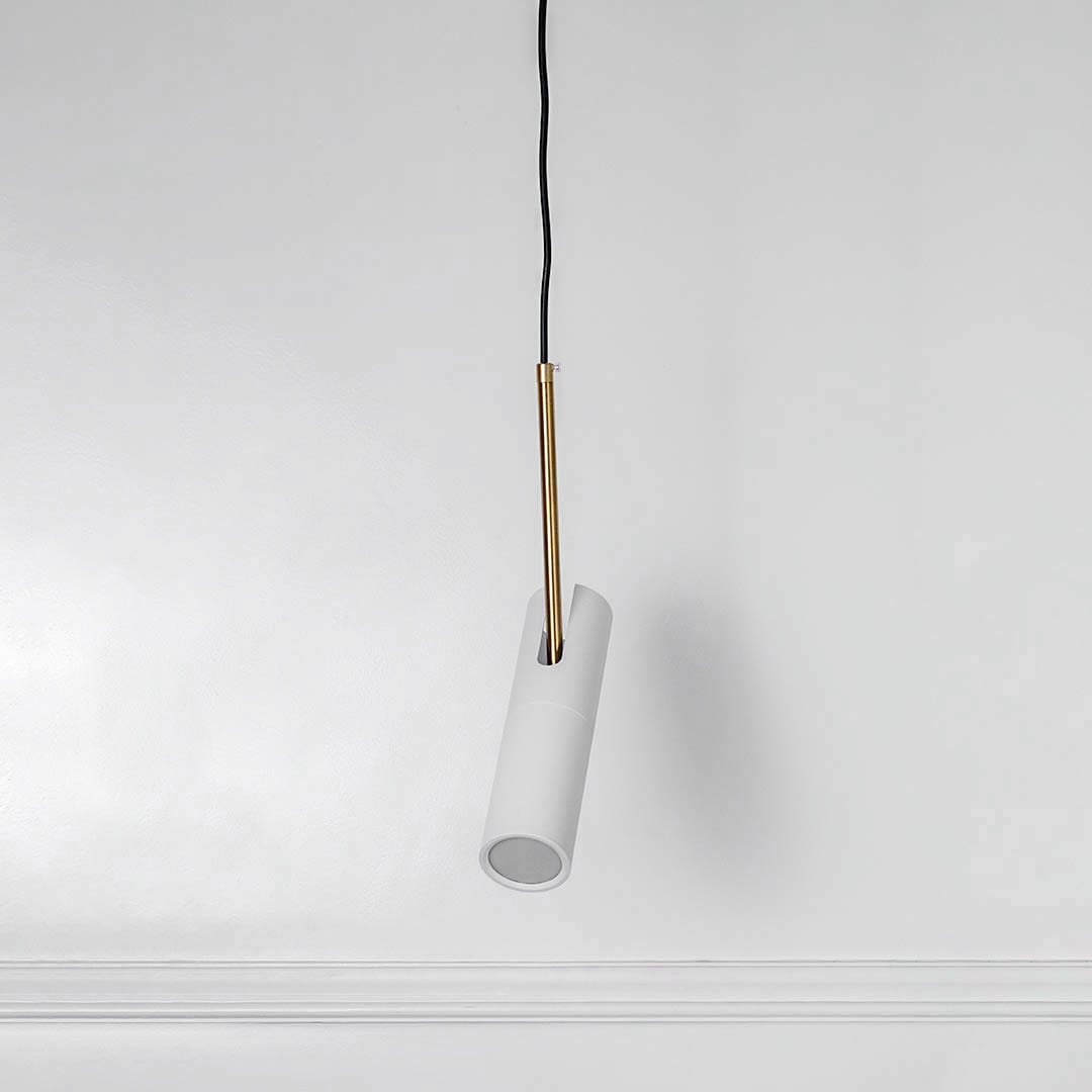 White cylindrical metal pendant light with polished gold details crafted for stylish modern spaces.
