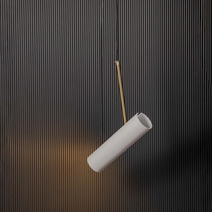 Modern white cylindrical pendant lamp glowing with golden accent warm light elegant ceiling fixture for luxury home interiors.