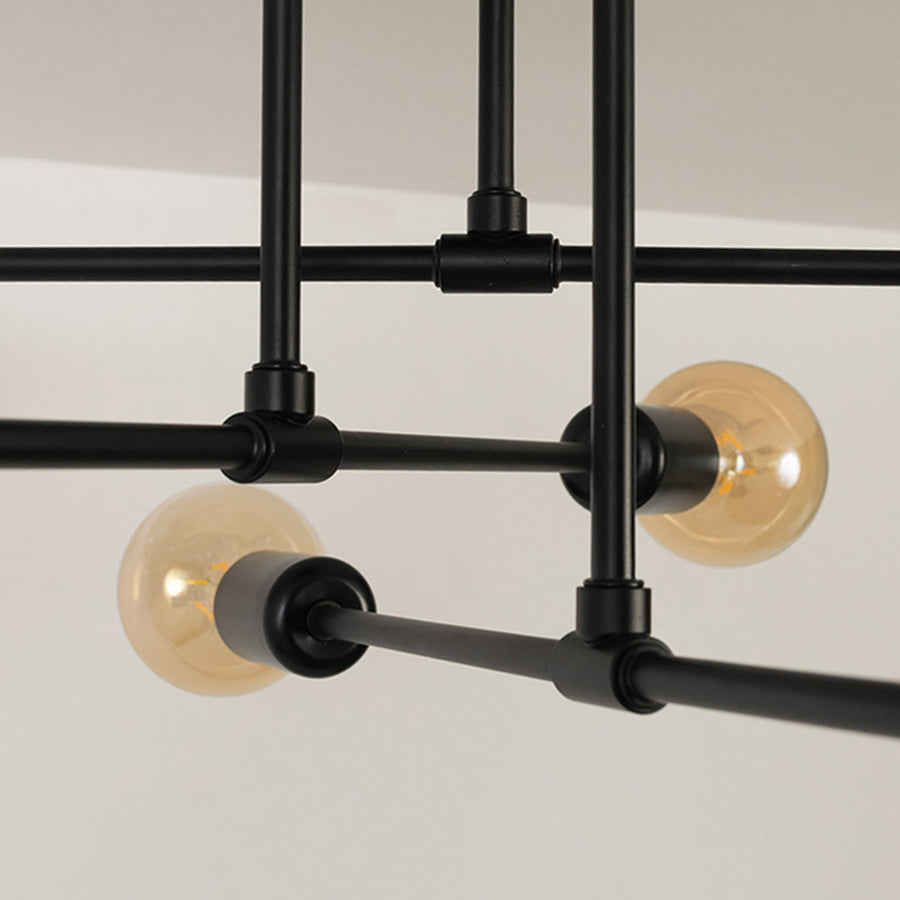Black metal chandelier with exposed amber glass bulbs featuring geometric metal detailing for stylish interior lighting.