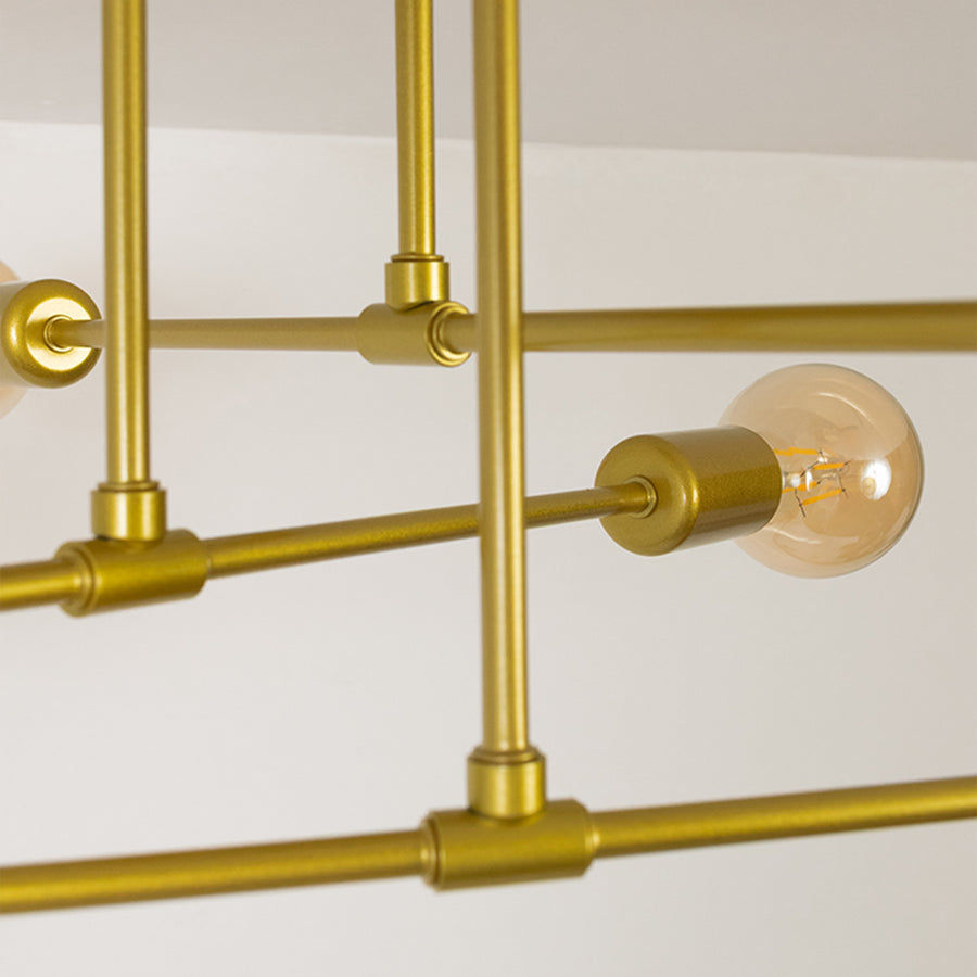 Gold metal chandelier with exposed amber glass bulbs highlighting premium craftsmanship and modern decorative lighting.