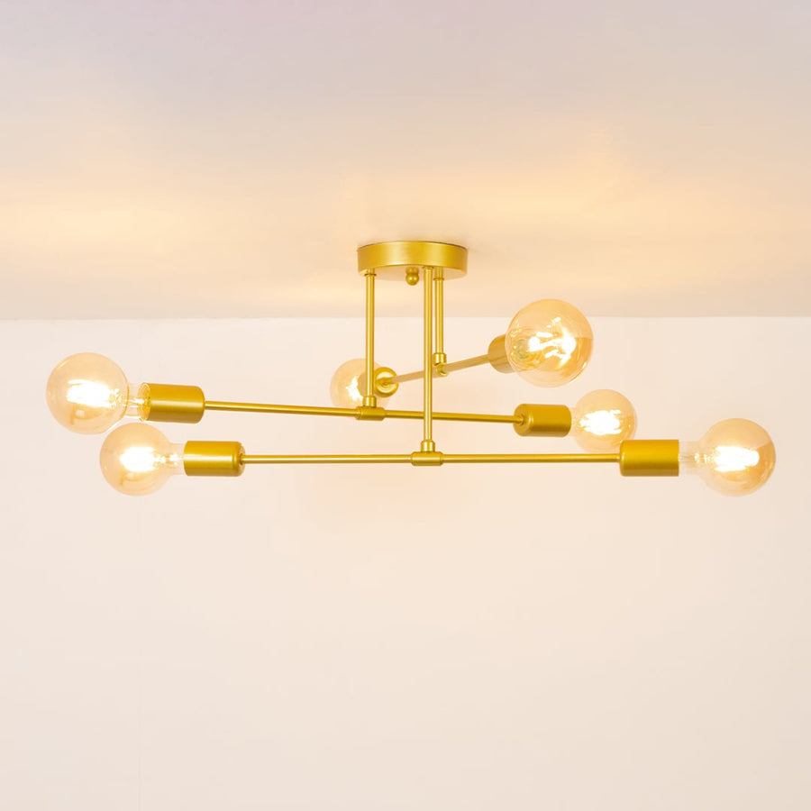 Gold chandelier glowing softly on a white background showcasing its warm illuminated bulbs and clean modern structure