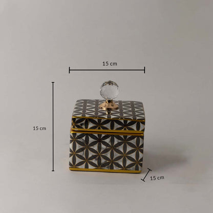Decorative black and gold ceramic jar with geometric pattern and crystal knob shown with 15 cm height and width.