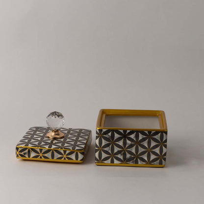 Handcrafted ceramic decor jar with geometric black and gold pattern and crystal top ideal for luxury interiors.