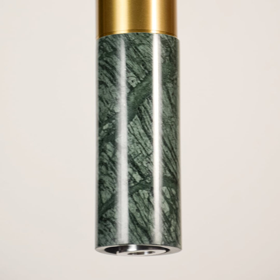 Green marble and gold metal pendant light closeup highlighting natural stone texture and premium craftsmanship.
