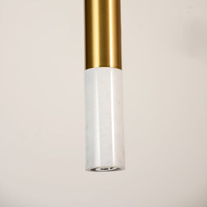 White marble and metal long cylinder pendant light shown in close up view with light off for clean contemporary décor.