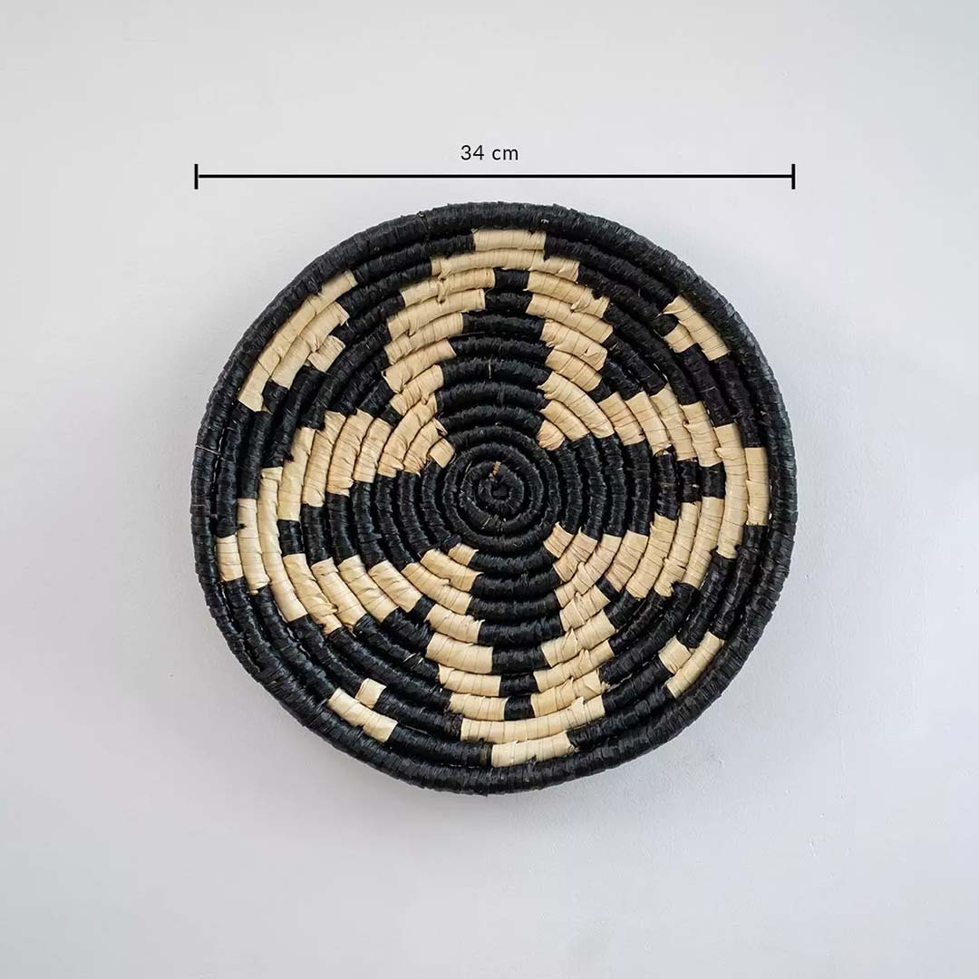 Circular woven wall basket in black and natural tones showing approx 28 cm diameter ideal for accent wall decor styling.
