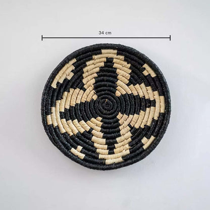 Circular woven wall basket in black and natural tones showing approx 28 cm diameter ideal for accent wall decor styling.
