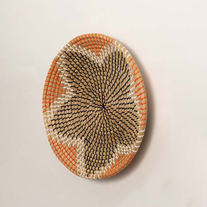 Side angle of woven basket wall plate showing depth coiled texture and handwoven craftsmanship in natural fibers.