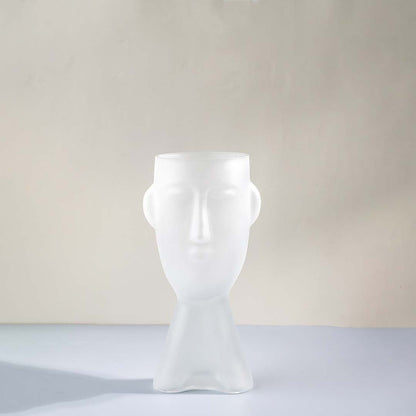 White glass decorative vase with sculptural human face design for shelf styling and contemporary home decor.
