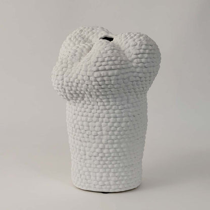 Side view of Pebble textured white ceramic vase displaying its uneven organic form and detailed artisanal surface.