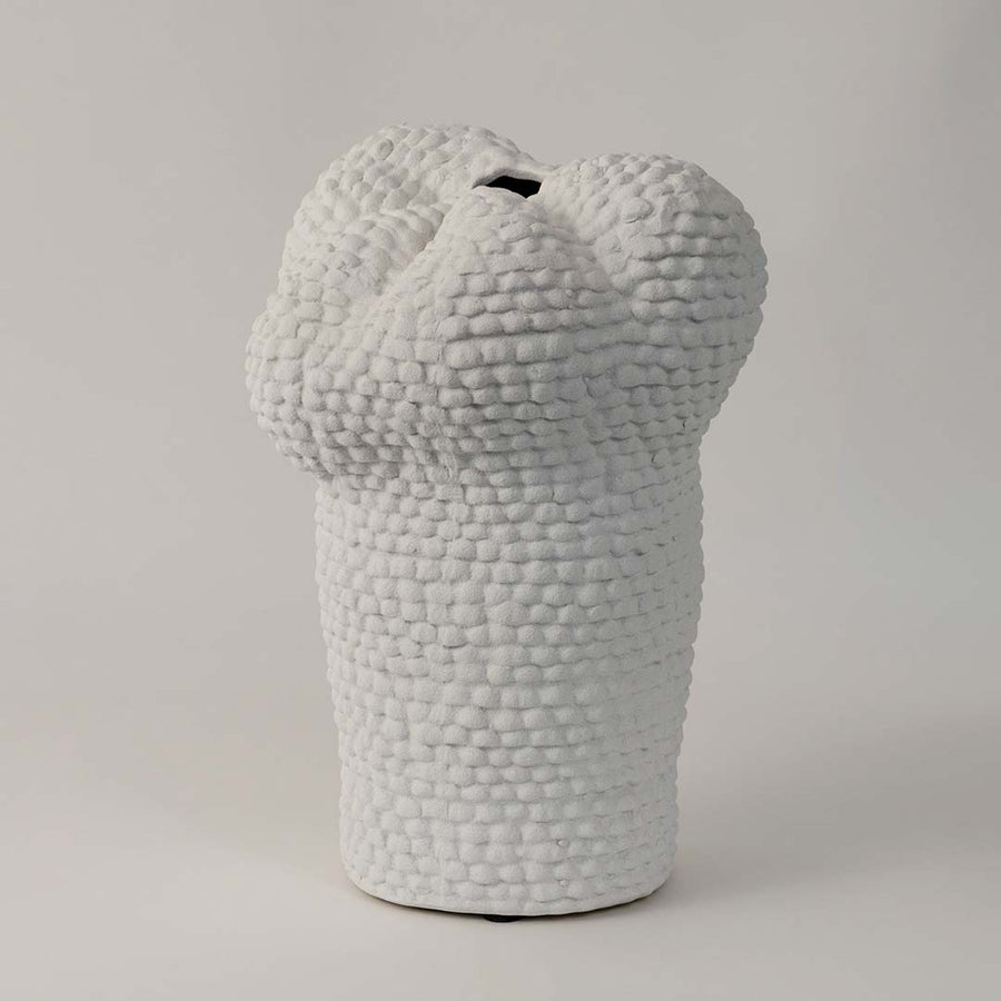 Side view of Pebble textured white ceramic vase displaying its uneven organic form and detailed artisanal surface.