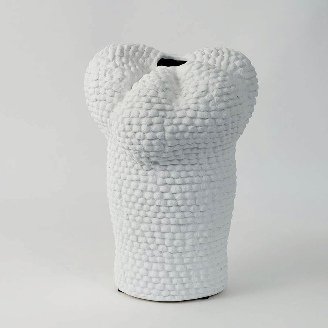 Minimal Pebble vase on a clean white background focusing on its organic curvy silhouette and pebble-inspired ceramic finish.