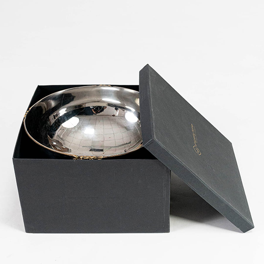 Silver interior fruit bowl with gold rim accents displayed inside a premium black gift box on a white background for gifting.