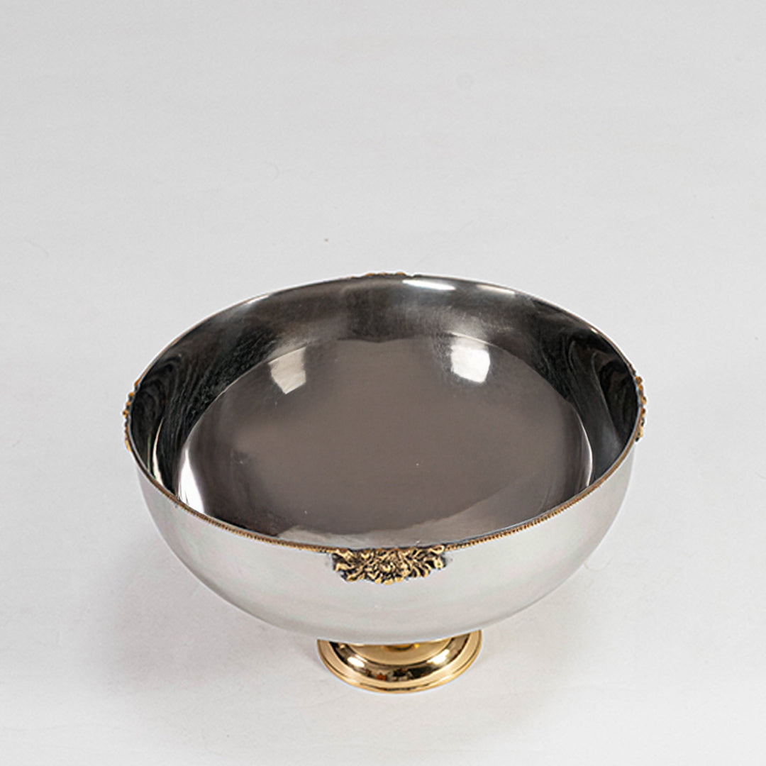 Modern metal bowl in silver finish with gold base for dining table or serving decor accessory placement white background.