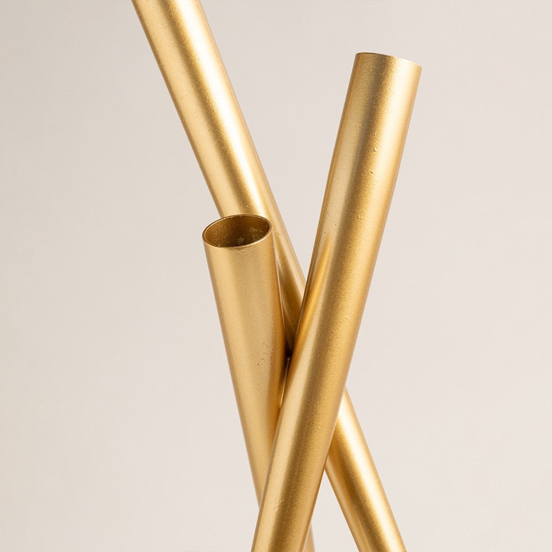 Detailed closeup highlighting the intersecting tubular structure and golden tone capturing the fine contours and sleek design of the vase.
