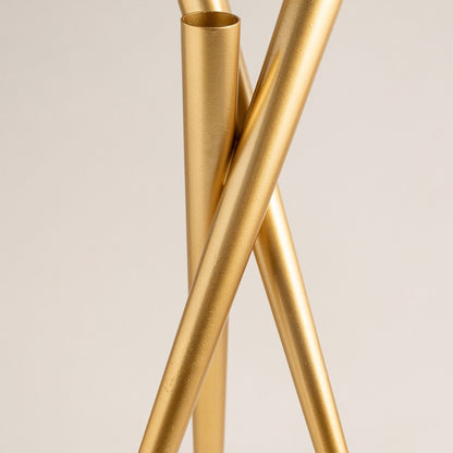 Closeup of gold metal floor lamp stand highlighting sleek finish and contemporary decorative craftsmanship details.