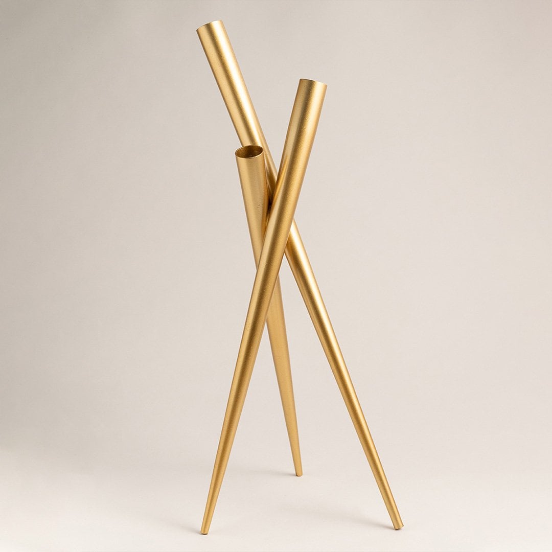 Gold metal vase photographed on a clean white background with soft lighting emphasizing its glossy golden finish and contemporary design for interior decor.