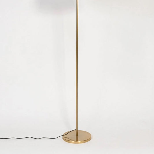 Minimalist floor lamp with slim gold metal stand and round base displayed on white background for modern living room lighting.