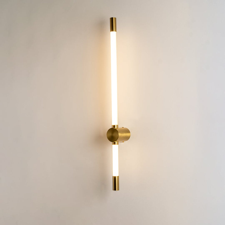 Modern gold LED wall light with warm ambient glow for elegant bedroom and luxury decor styling spaces.

