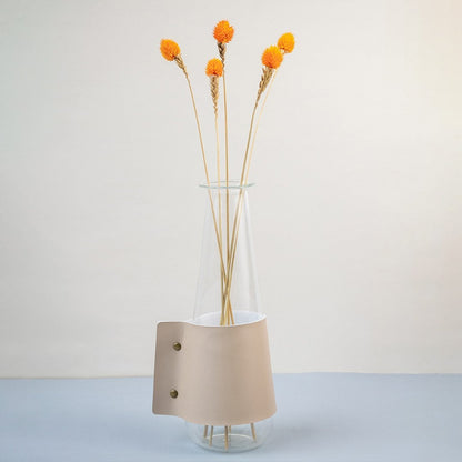 Bright orange dried flower stem styled in a warm modern room adding a bold natural accent to contemporary home decor.