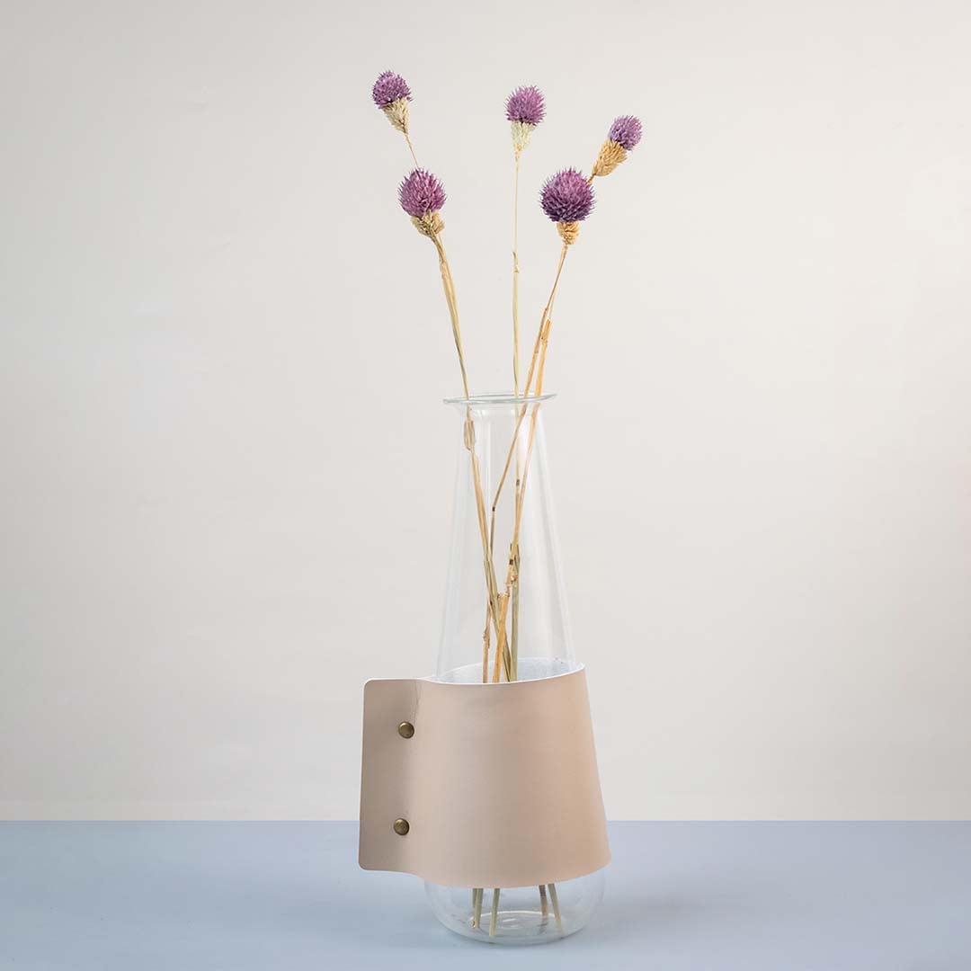 Soft purple dried flower stem styled in a warm modern room adding a gentle natural accent to contemporary home decor.