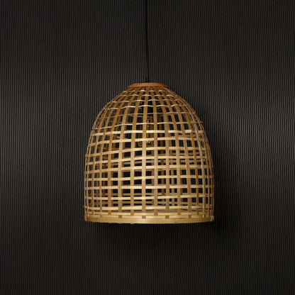 Natural bamboo pendant light illuminated beautifully on black background creating rustic warm home vibe.
