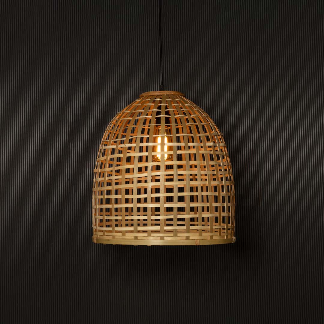 Elegant bamboo hanging lamp with warm glow highlighted on dark background for stylish interior ambience.