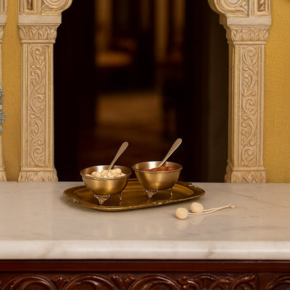 Gold metal condiment bowl set lifestyle image on marble countertop for elegant luxury dining table decor.