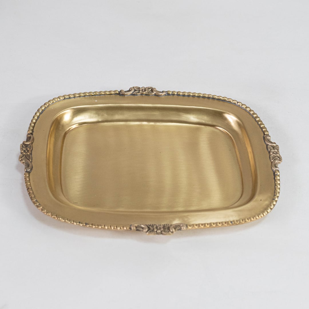 Rectangular gold tray with ornate edging and flat base designed for festive or formal serving use on white surface.