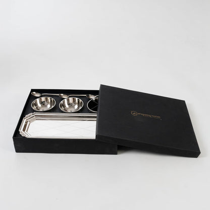 Silver condiment set presented in an open black gift box on a white background highlighting the polished bowls spoons and tray in a premium layout.