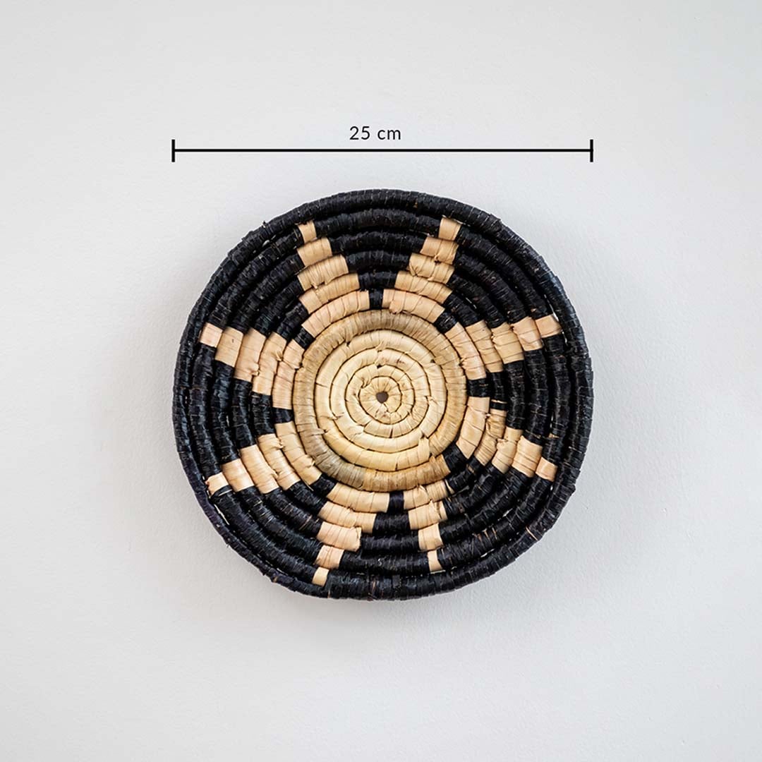 Circular woven wall basket with black border and natural center displaying approx 30 cm diameter for decorative wall styling.