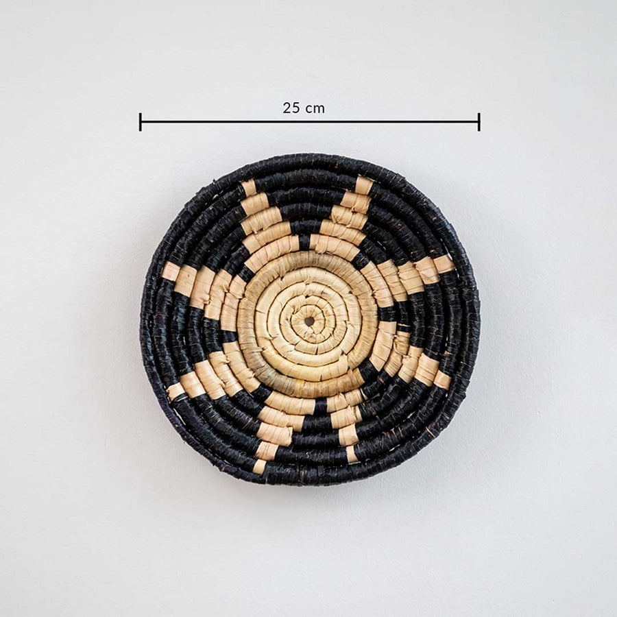 Circular woven wall basket with black border and natural center displaying approx 30 cm diameter for decorative wall styling.