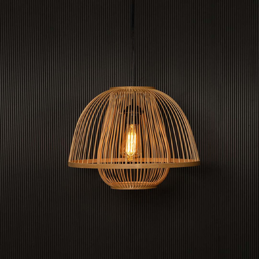 Natural rattan pendant light illuminated with warm glow creating cozy ambience for dining room interiors.