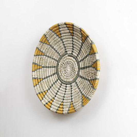 Handwoven wall plate viewed from the side showing its textured depth and woven craftsmanship designed to add natural character to interior walls.