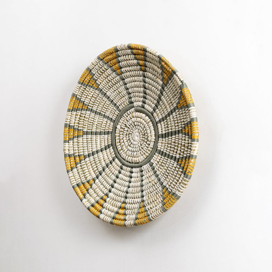 Handwoven wall plate viewed from the side showing its textured depth and woven craftsmanship designed to add natural character to interior walls.