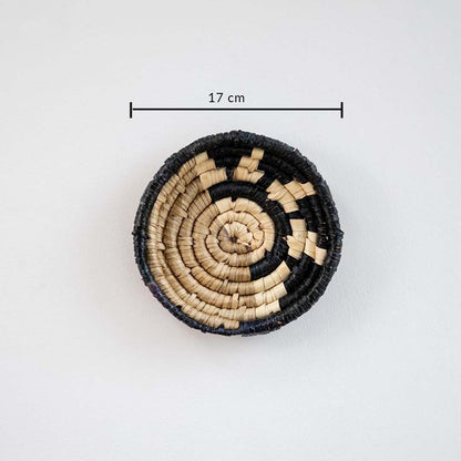 Small handcrafted round wall basket in black and beige tones showing approx 17 cm diameter ideal for compact wall decor.