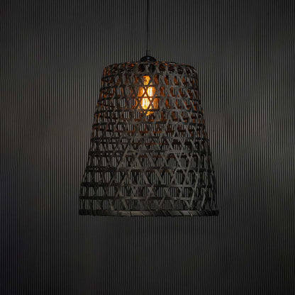 Woven bamboo pendant light glowing warmly on black background creating a cozy and elegant interior ambience.