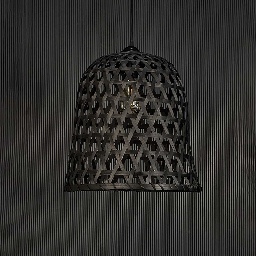 Woven black rattan pendant light on dark background highlighting its handcrafted texture and elegant silhouette.