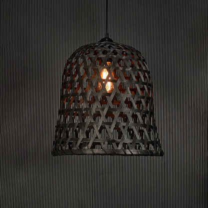 Rattan pendant light glowing warmly on black background showcasing its geometric pattern and ambient illumination.