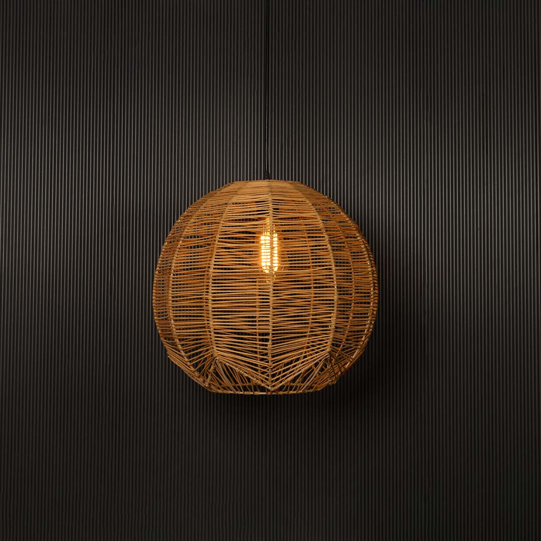 Natural rattan pendant light on white background glowing softly for a warm organic aesthetic.