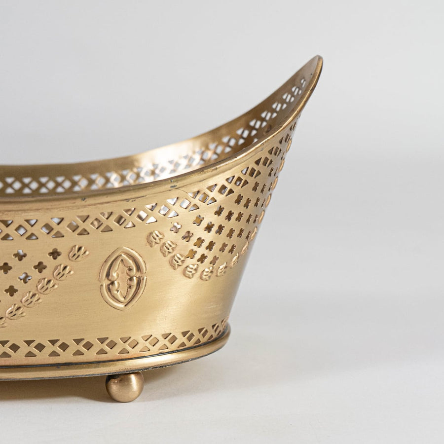 Detailed closeup of gold fruit bowl showing embossed edge trim and round foot design with elegant matte finish.