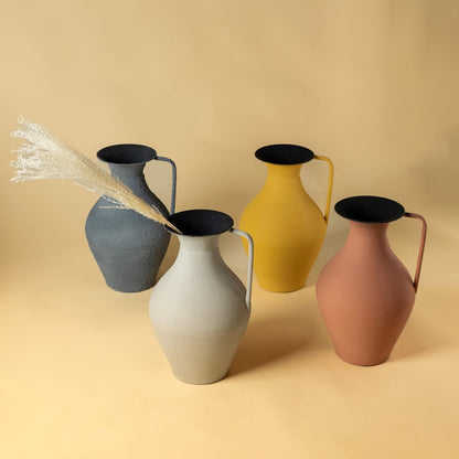 Closeup grouped ceramic pitcher style vases in pastel and earthy colors showcasing smooth texture and modern decorative appeal.